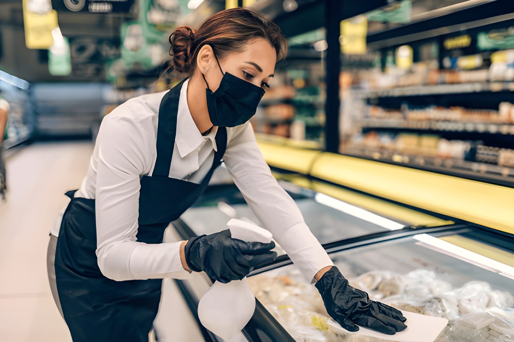 Shop Cleaning Services 11 Cleaner disinfecting high-touch surfaces in mall store