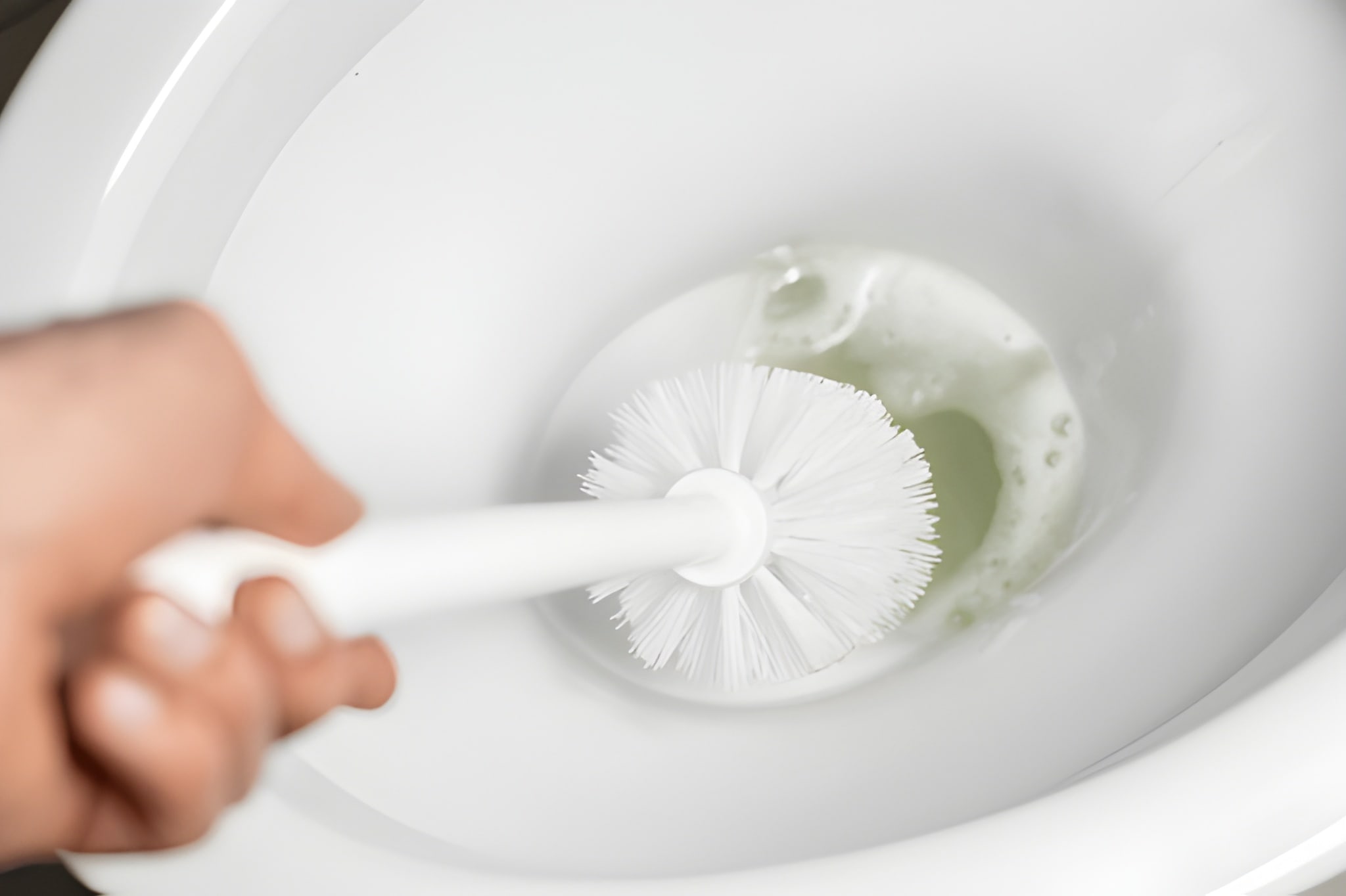 Professional toilet bowl cleaning in Dubai using brush and eco friendly cleaner